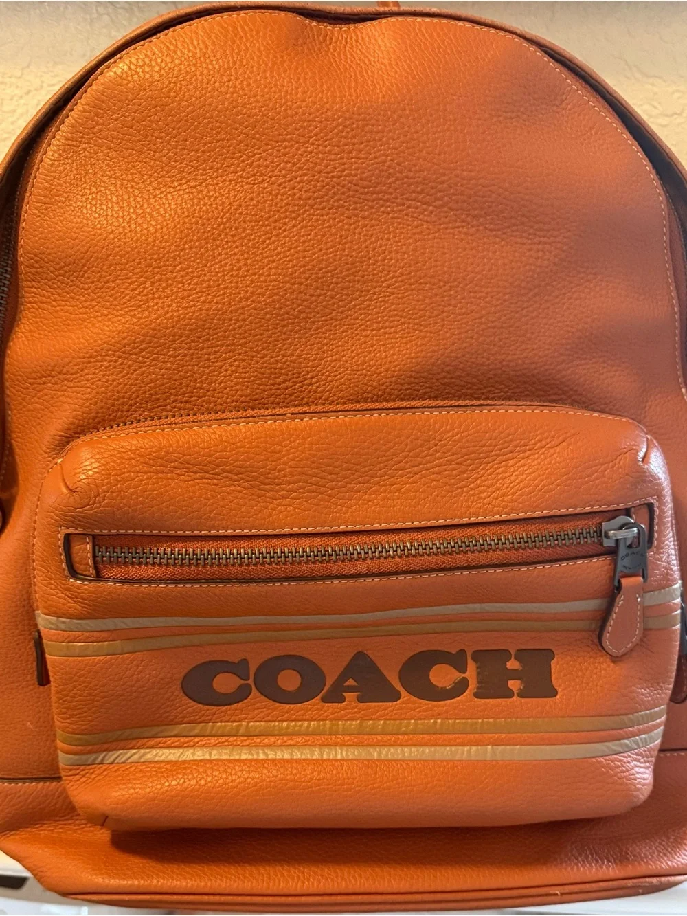 COACH Orange Pebbled Leather Men's Backpack with Front Logo Pocket